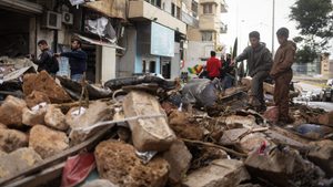 People look at the aftermath of an Israeli strike in Beirut, Lebanon. Rebuilding costs could reach an estimated $25bn