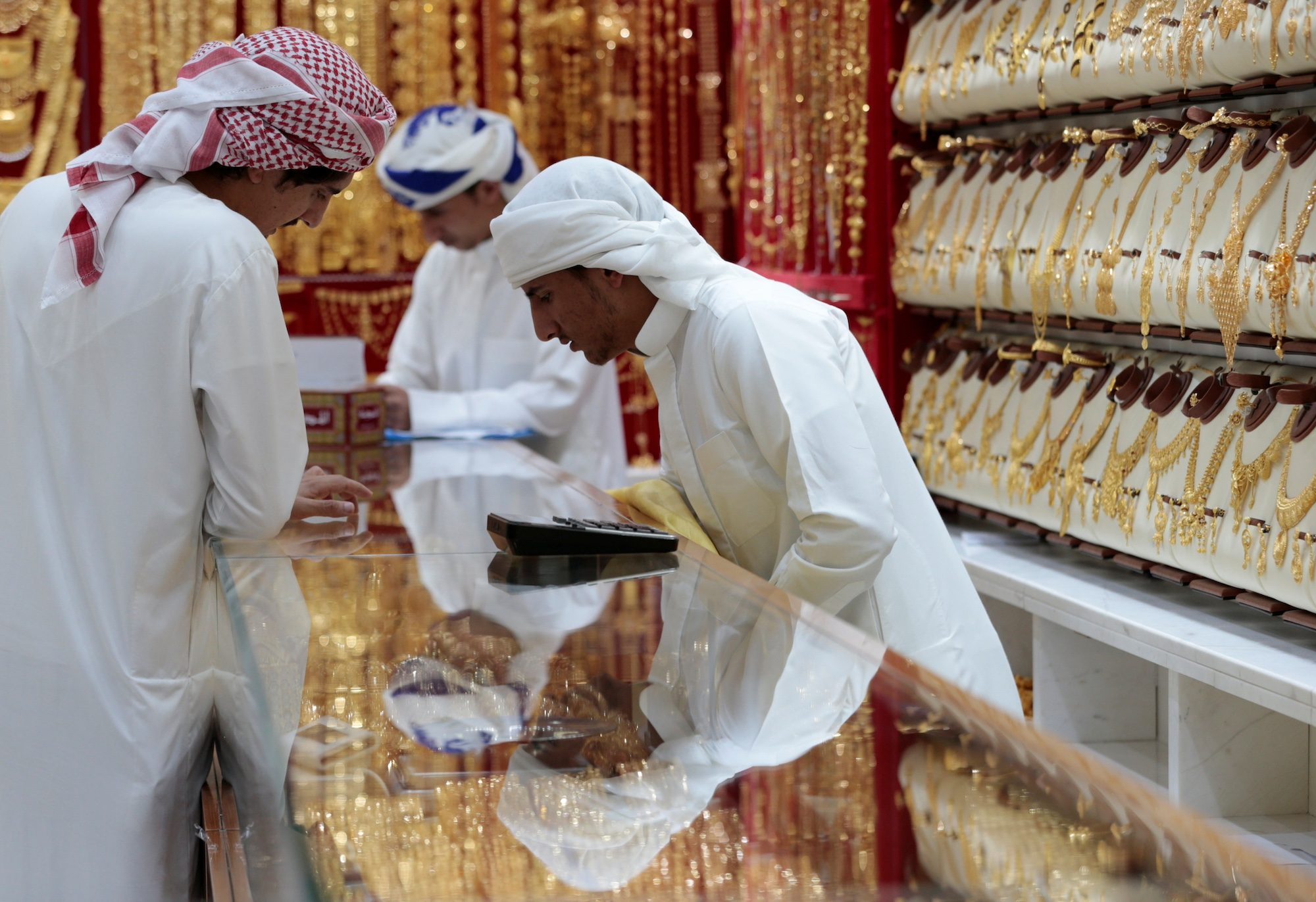 Men look at jewellery in the gold souk, Dubai. An unprecedented amount of gold has been sent from Dubai and other markets to New York in recent days in response to tariffs