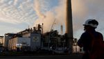 A worker at an ExxonMobil oil refinery. The company has maintained its capex guidance and will work with Adnoc